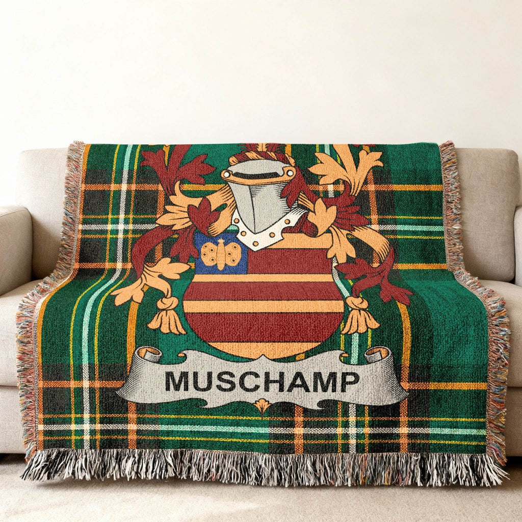 Green tartan blanket with the Muschamp family crest.