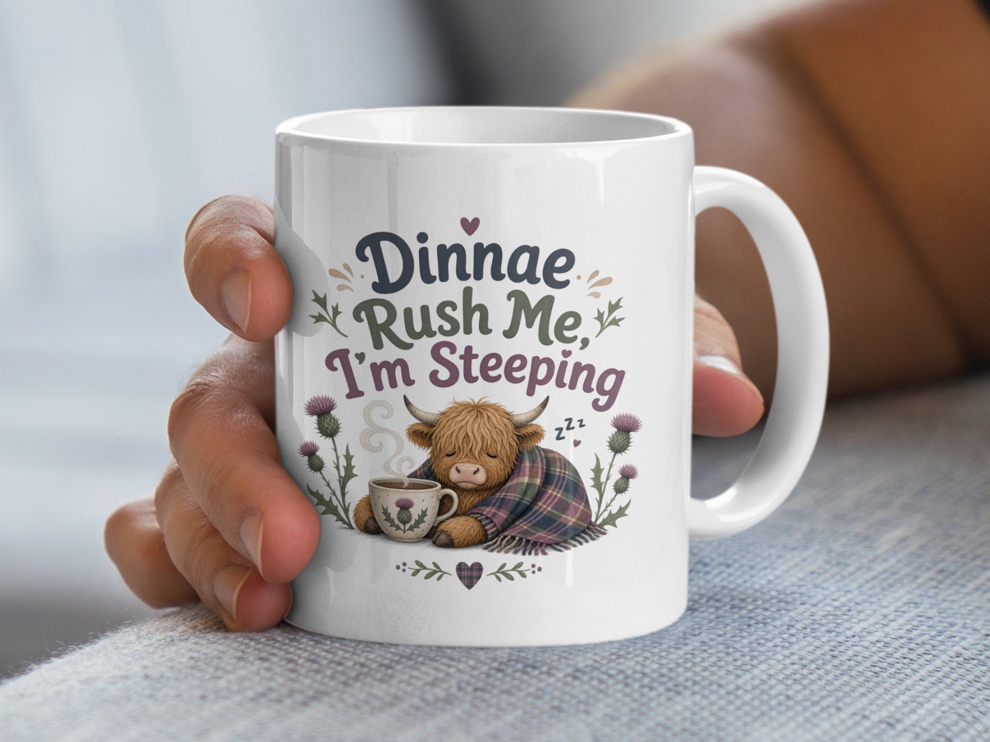 White mug with fluffy highland cow and "Dinnae Rush Me, I'm Steeping" text.