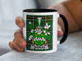 White mug with Quarles family crest on green plaid background.