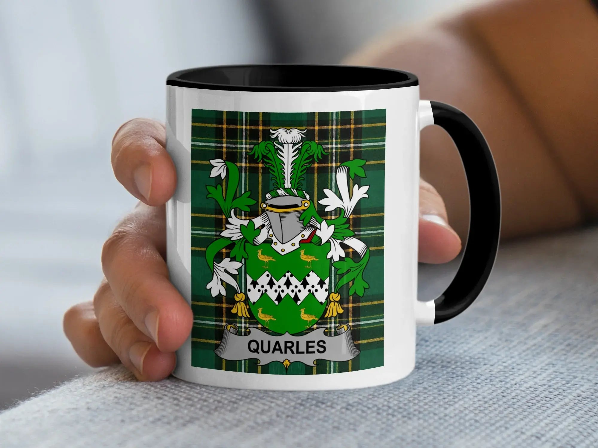 White mug with Quarles family crest on green plaid background.