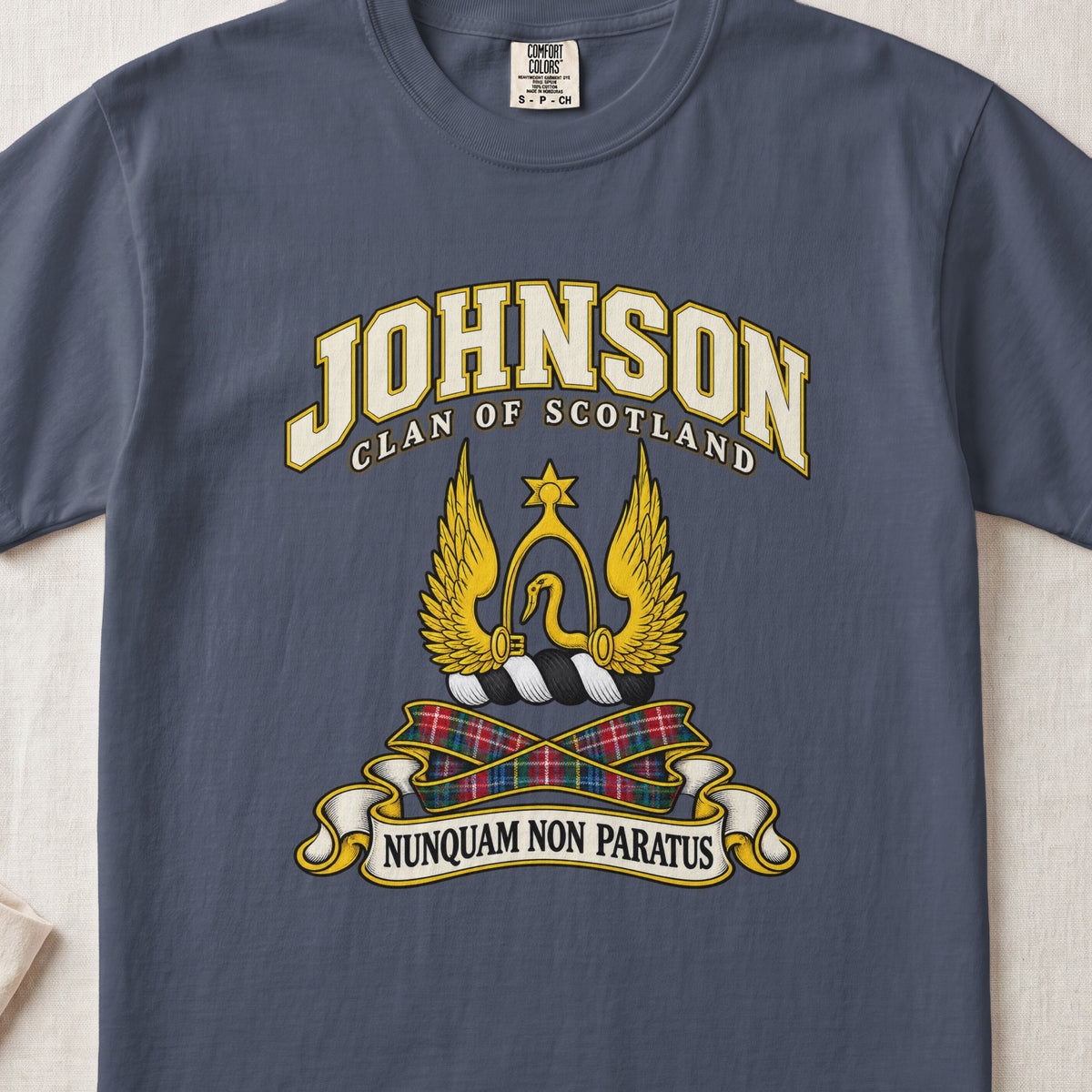 Johnson Scottish clan T-shirt in Midnight, front view with a golden winged emblem beneath a star and motto banner.