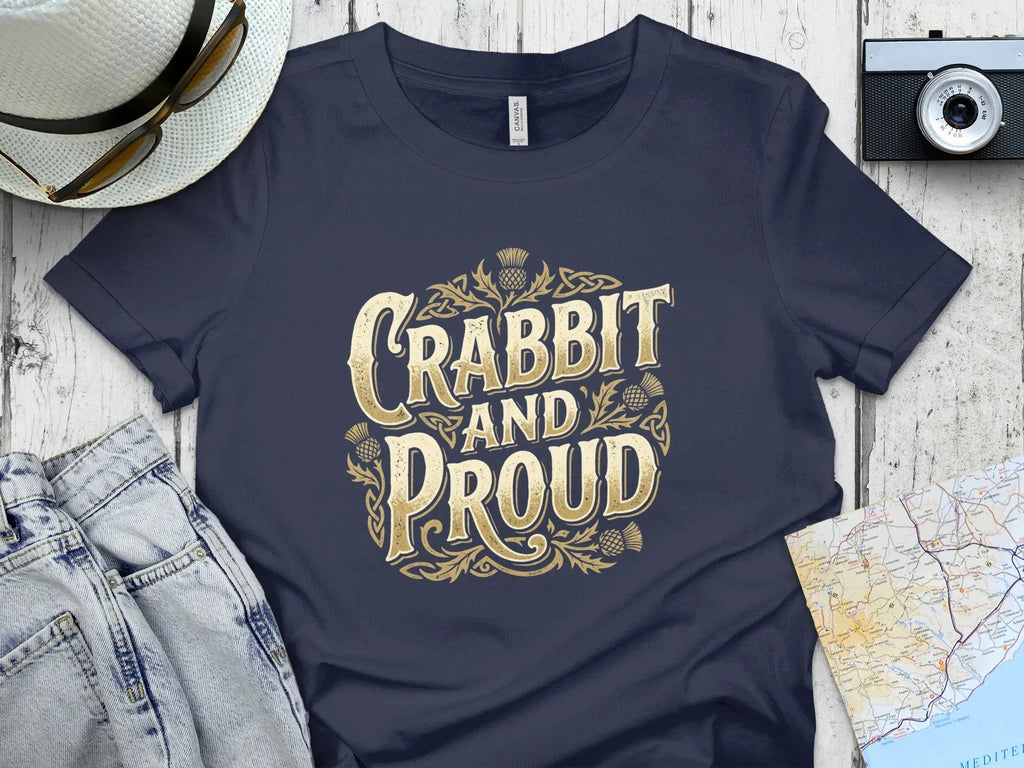 Navy t-shirt with "Crabbit and Proud" text in gold Celtic knot design.