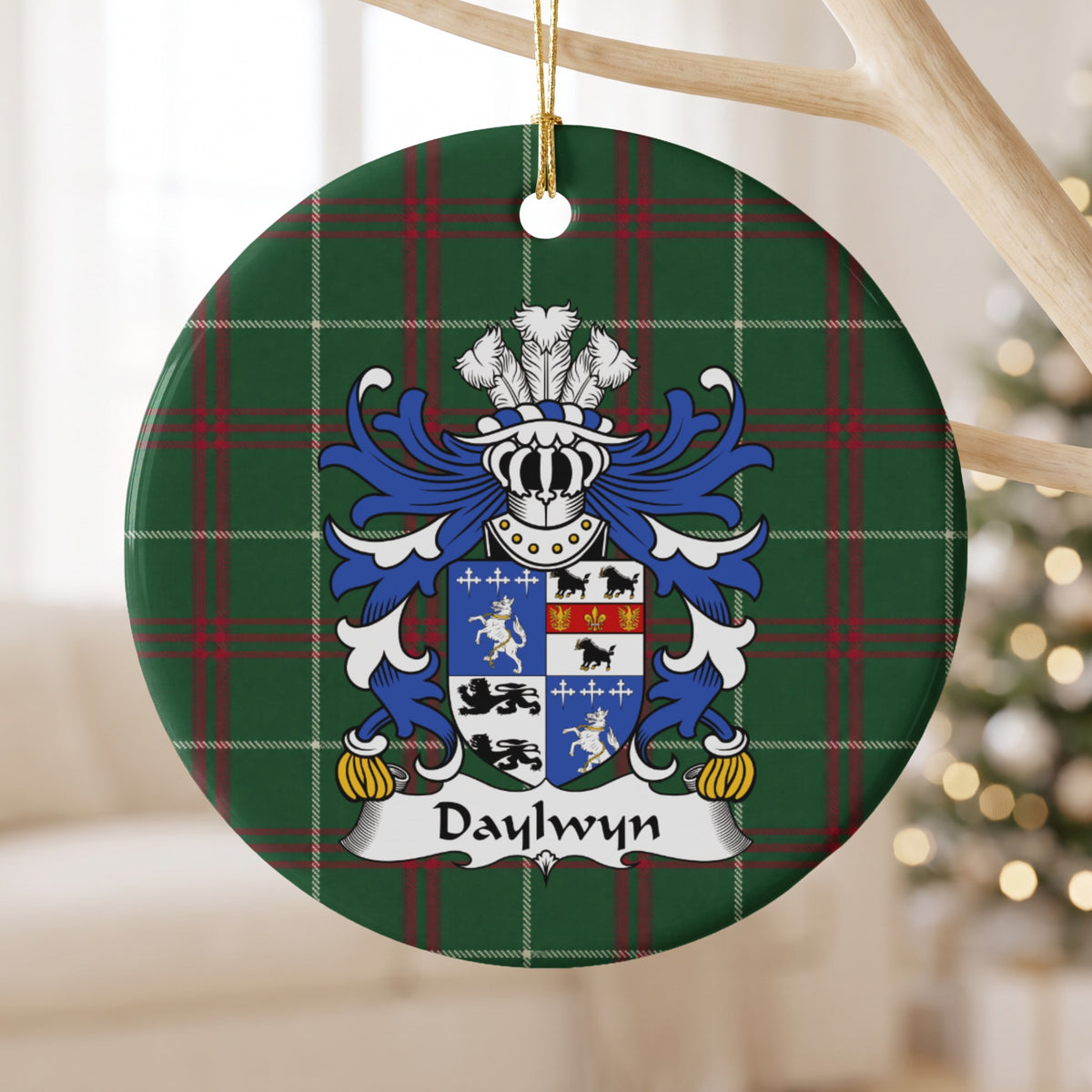 Daylwyn ornament hanging from a pale wooden branch; a quartered blue-and-white shield with lions, dark animals and small cross motifs on Welsh national tartan.