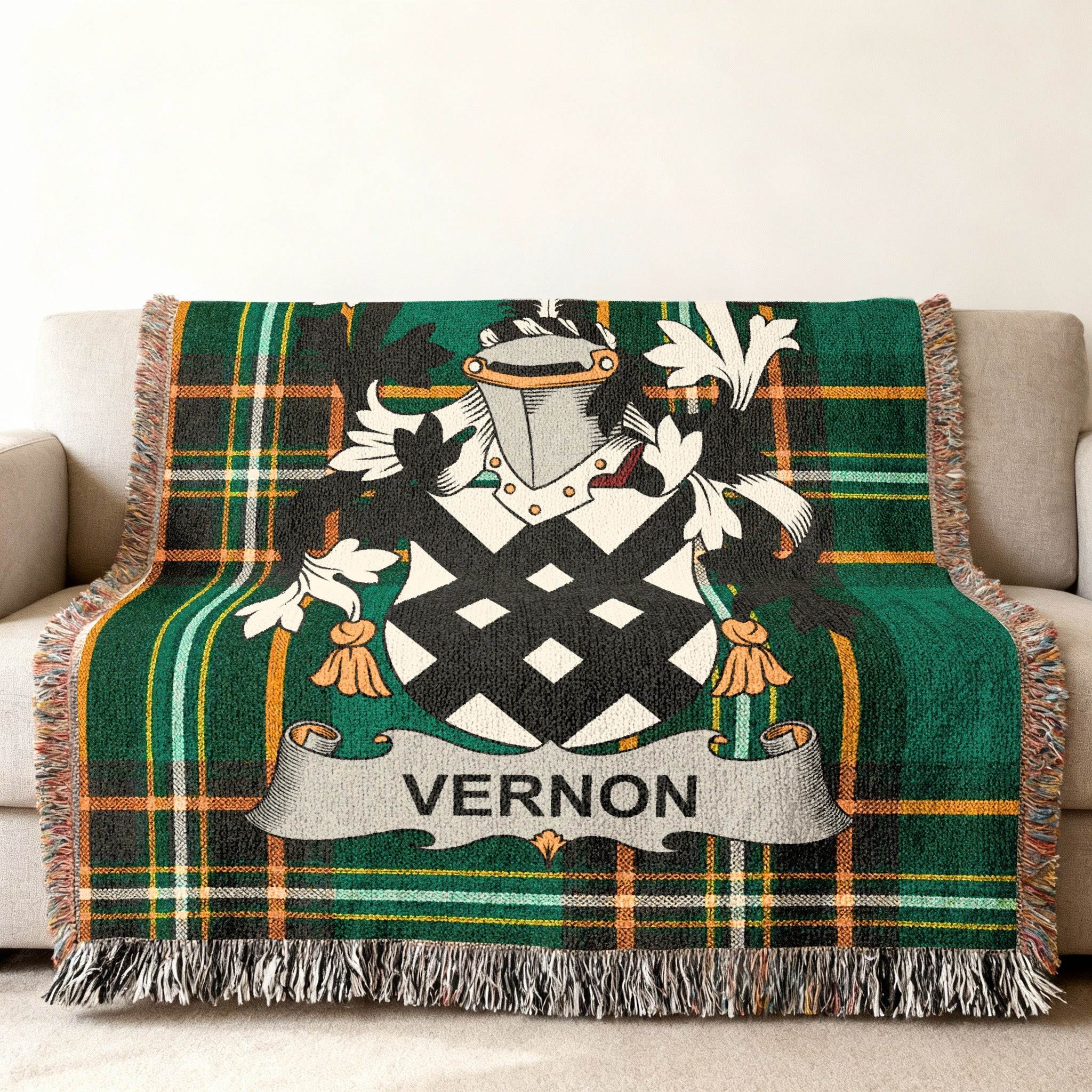 Tartan blanket with Vernon family crest draped on a sofa.
