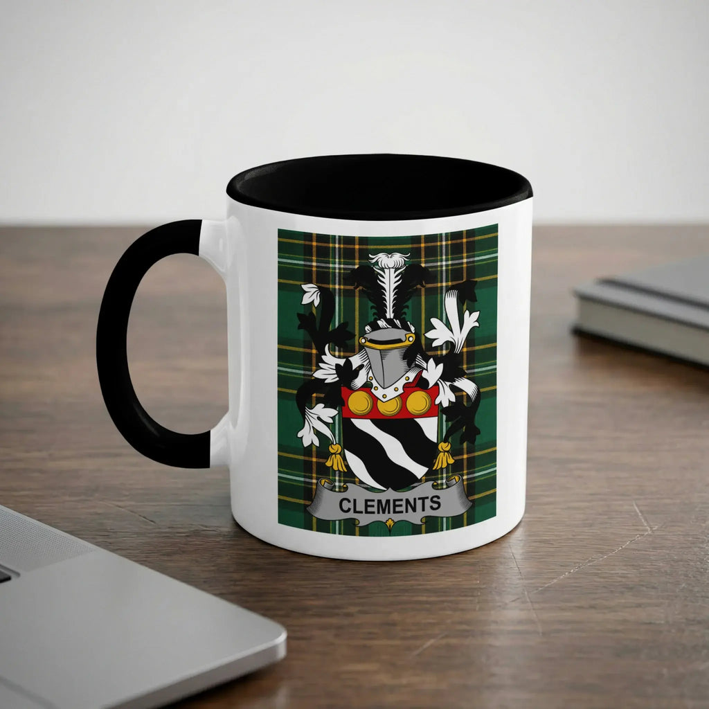 White mug with black rim featuring the Clements family crest and plaid background.