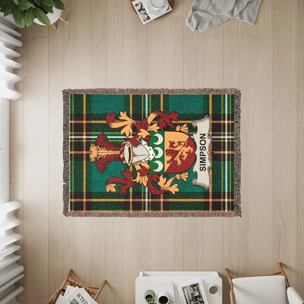 Simpson family crest on a green tartan plaid woven throw blanket.