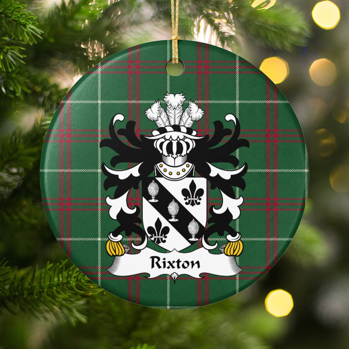 Rixton Welsh National Tartan ornament hanging on a lit Christmas tree, featuring a black diagonal band with three silver covered cups between black fleurs-de-lis.