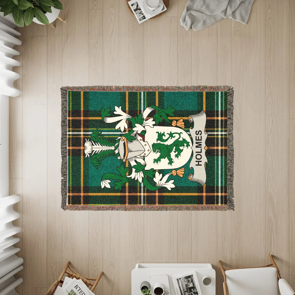 Holmes family crest on a green plaid woven blanket.