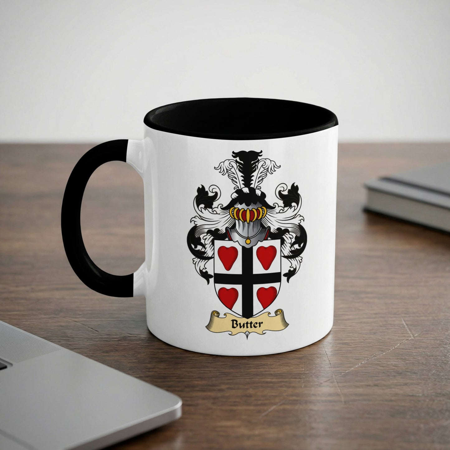 White mug with black rim featuring a coat of arms with "Butter" text.
