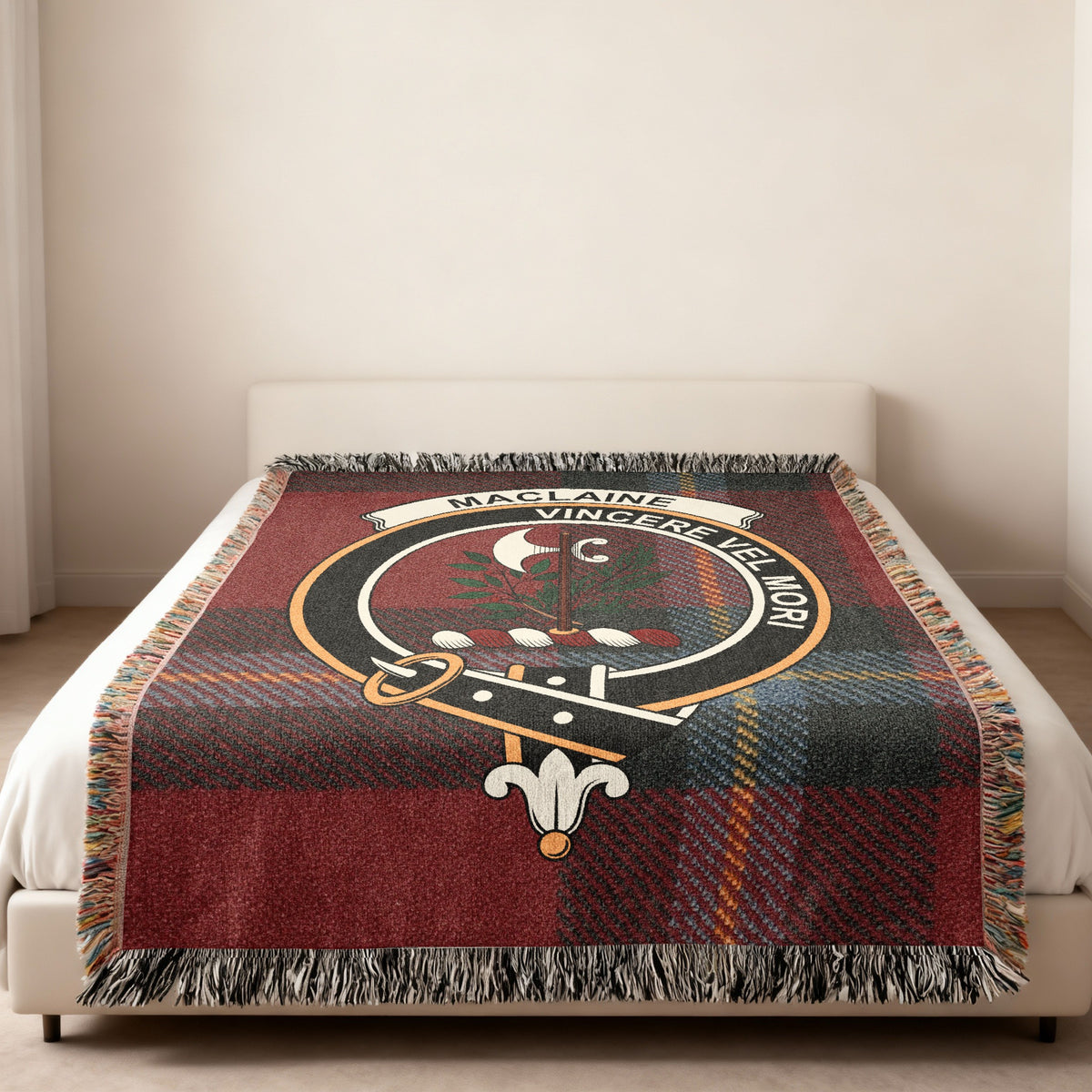 MacLaine of Lochbuie Scottish woven blanket spread across a bed, showing the full crest design and tartan background