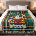 Plaid blanket featuring the Walron family crest on a bed.
