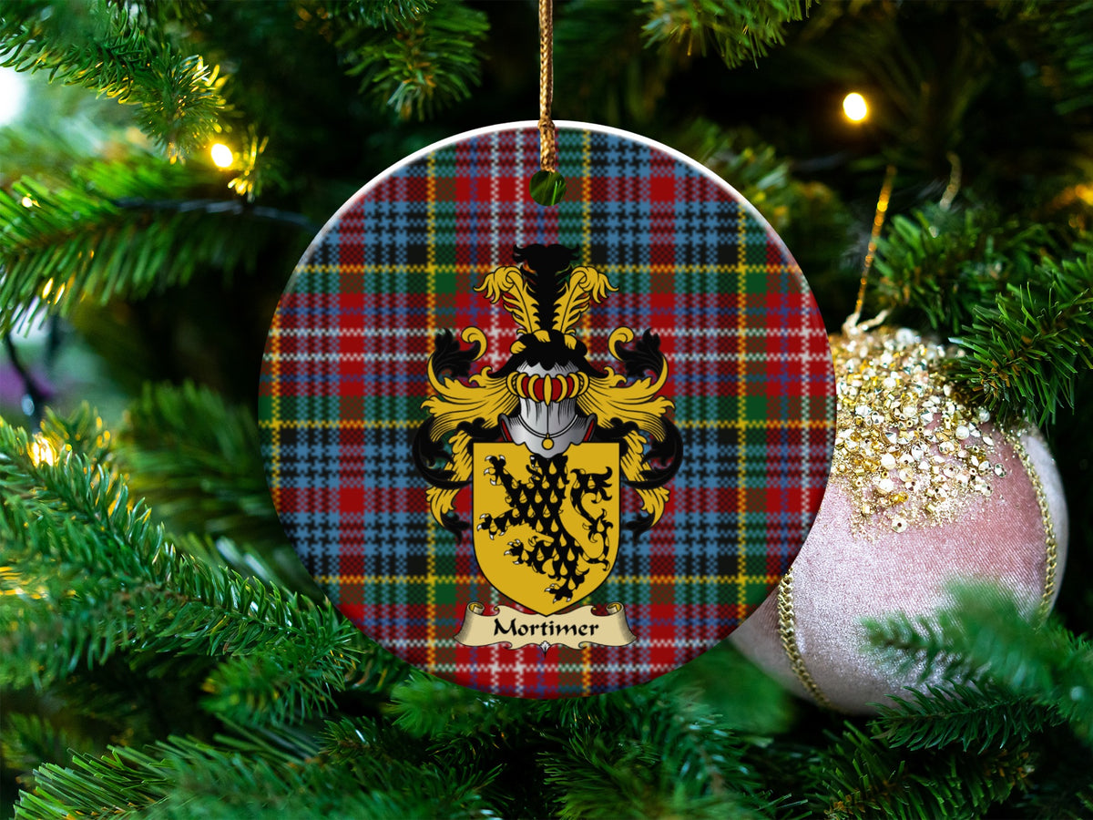 Mortimer Scottish clan ceramic ornament with family crest on a Caledonia tartan background, hanging on a Christmas tree