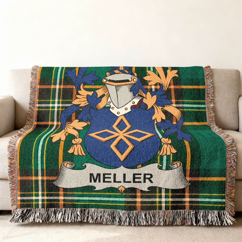 Green plaid throw blanket featuring the Meller family crest with a blue shield.