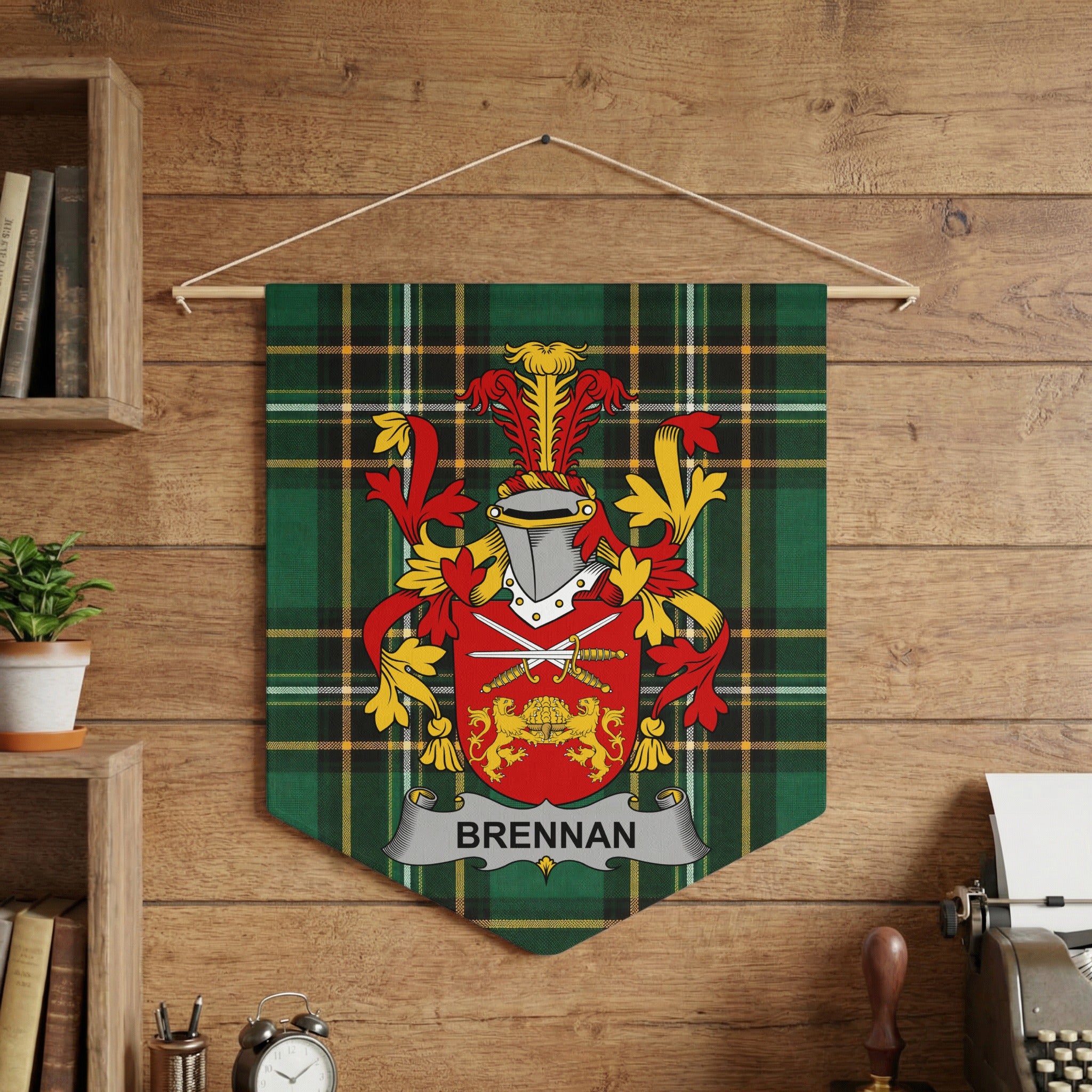 Brennan family crest displayed on a green tartan pennant hanging on a wooden wall.