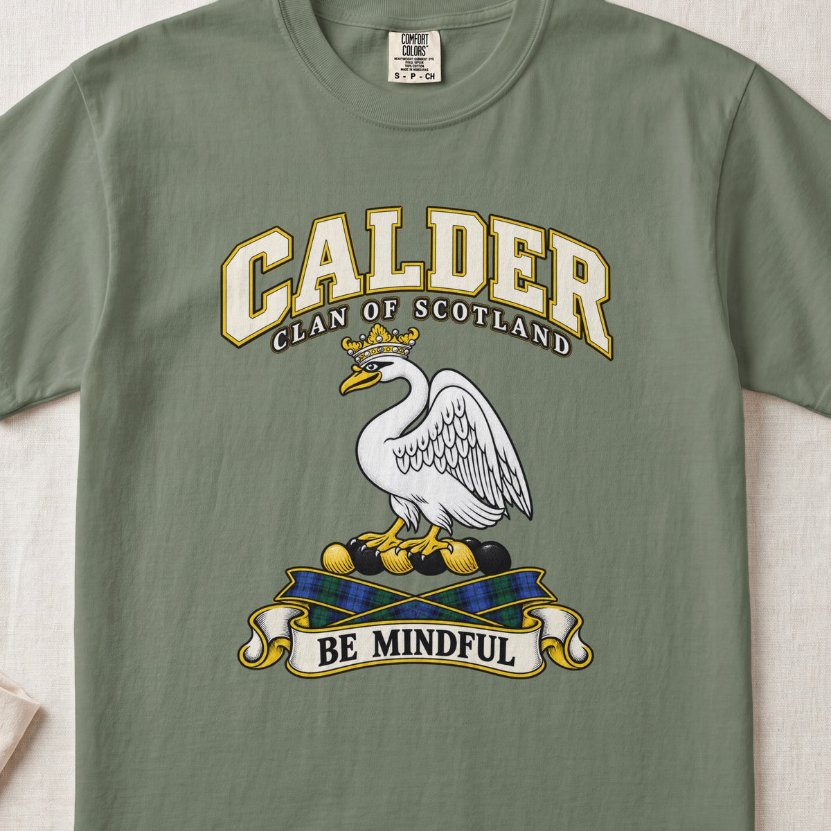 Calder Scottish clan T-shirt in Moss, front view with a white swan wearing a gold crown and motto banner.