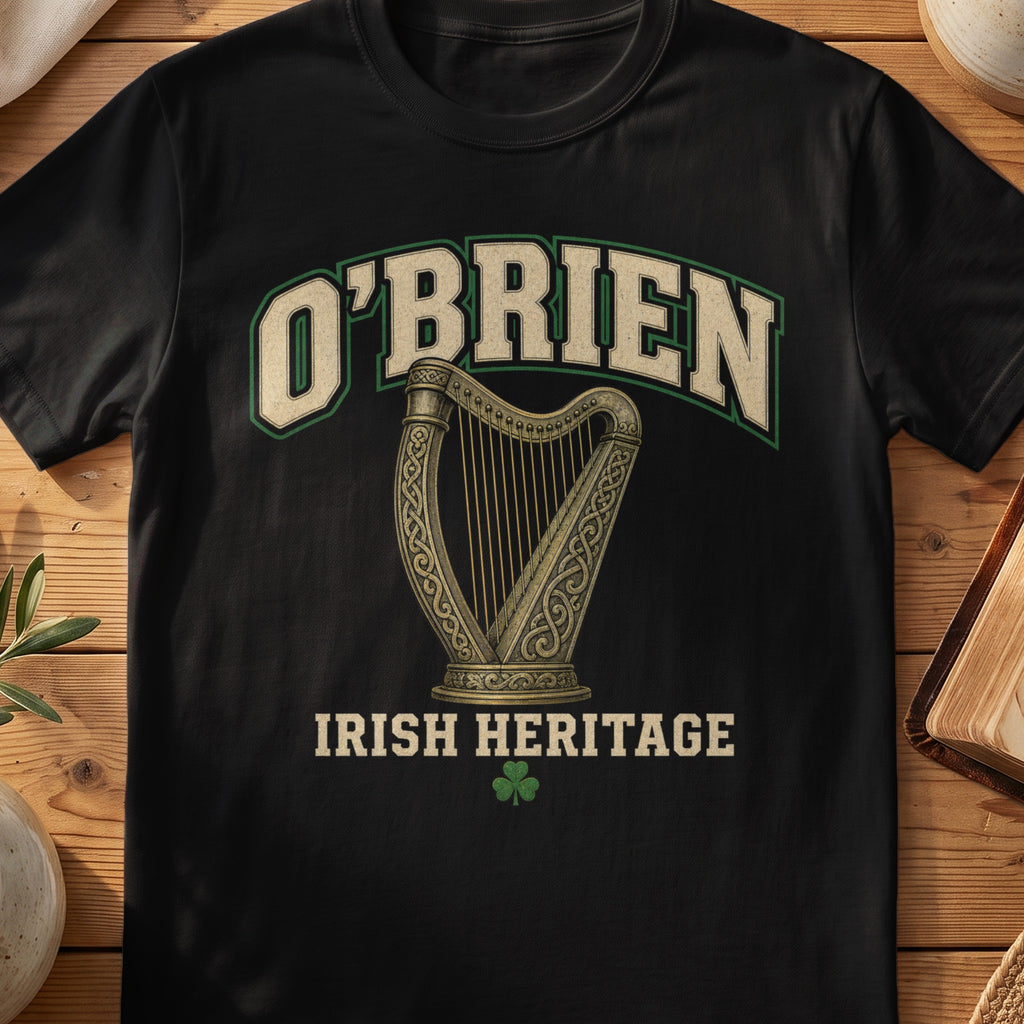 O'Brien Irish harp T-shirt in Black, with cream surname lettering, a gold-toned harp, green shamrock and “Irish Heritage” text.