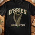 O'Brien Irish harp T-shirt in Black, with cream surname lettering, a gold-toned harp, green shamrock and “Irish Heritage” text.