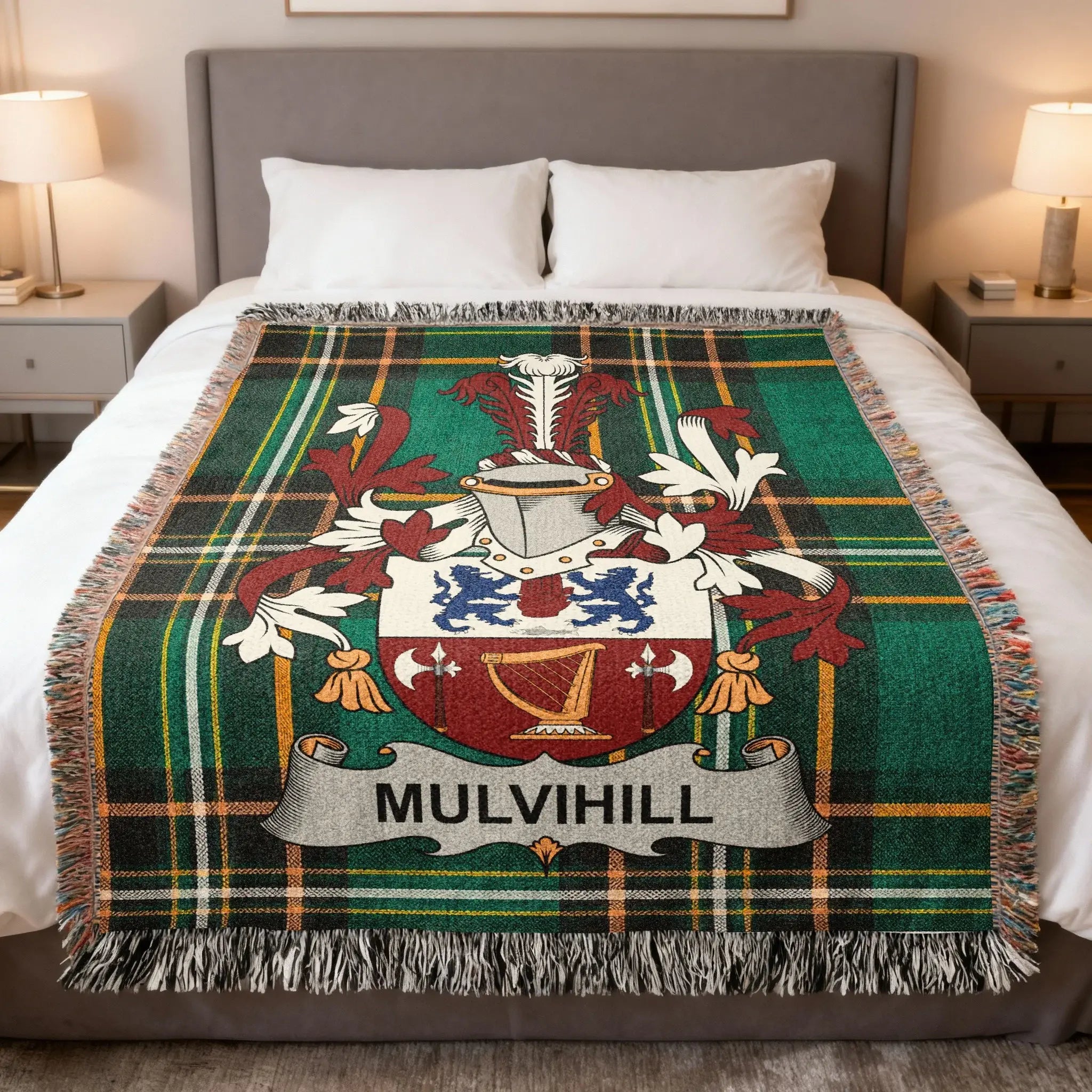 Tartan blanket featuring the Mulvihill family crest on a bed.