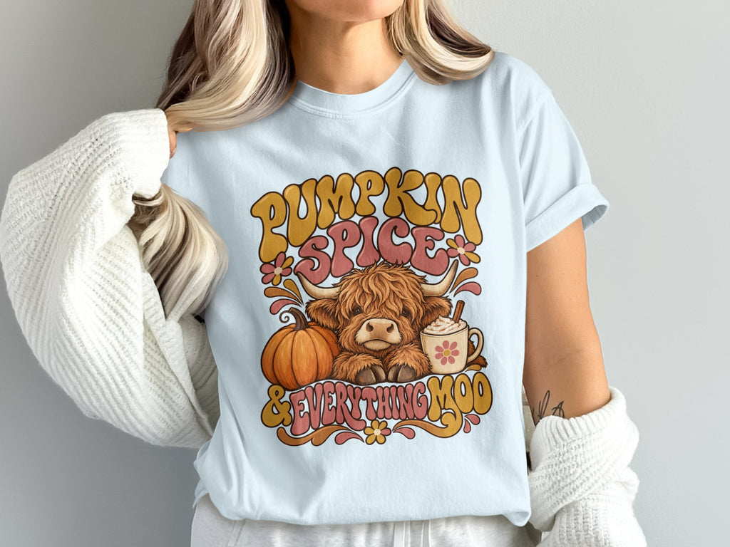 Model wearing the Pumpkin Spice & Everything Moo Highland cow Comfort Colors T-shirt in Chambray