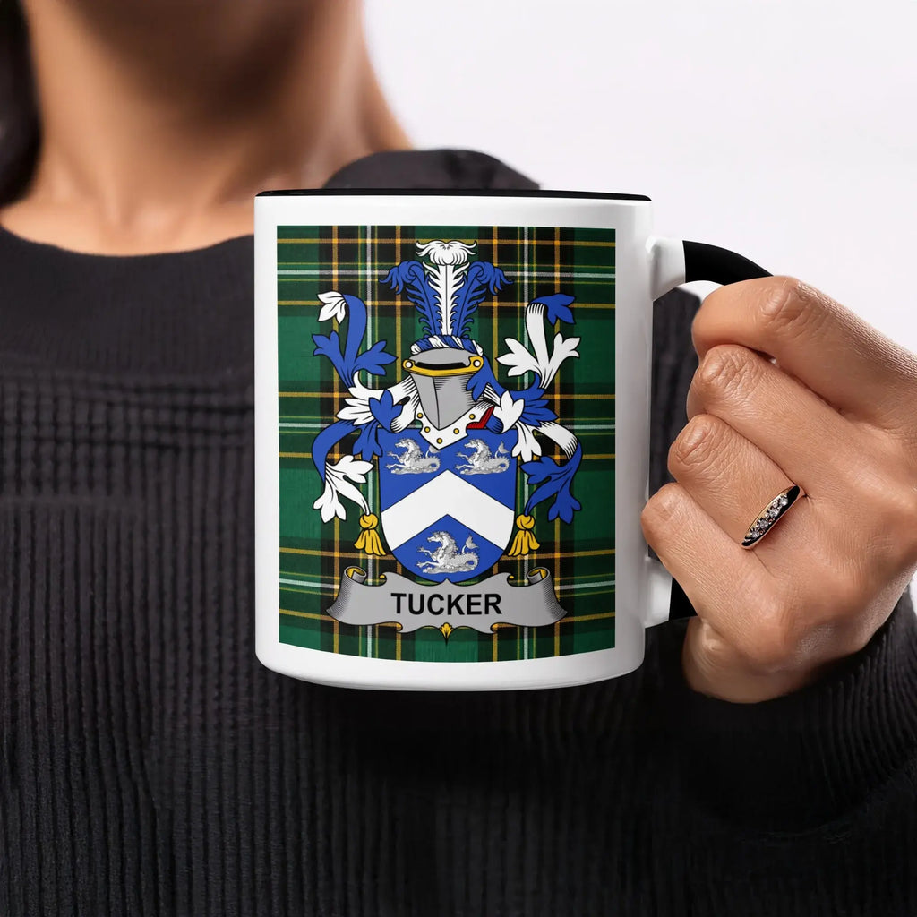 Tucker family crest on a white mug with a black rim.