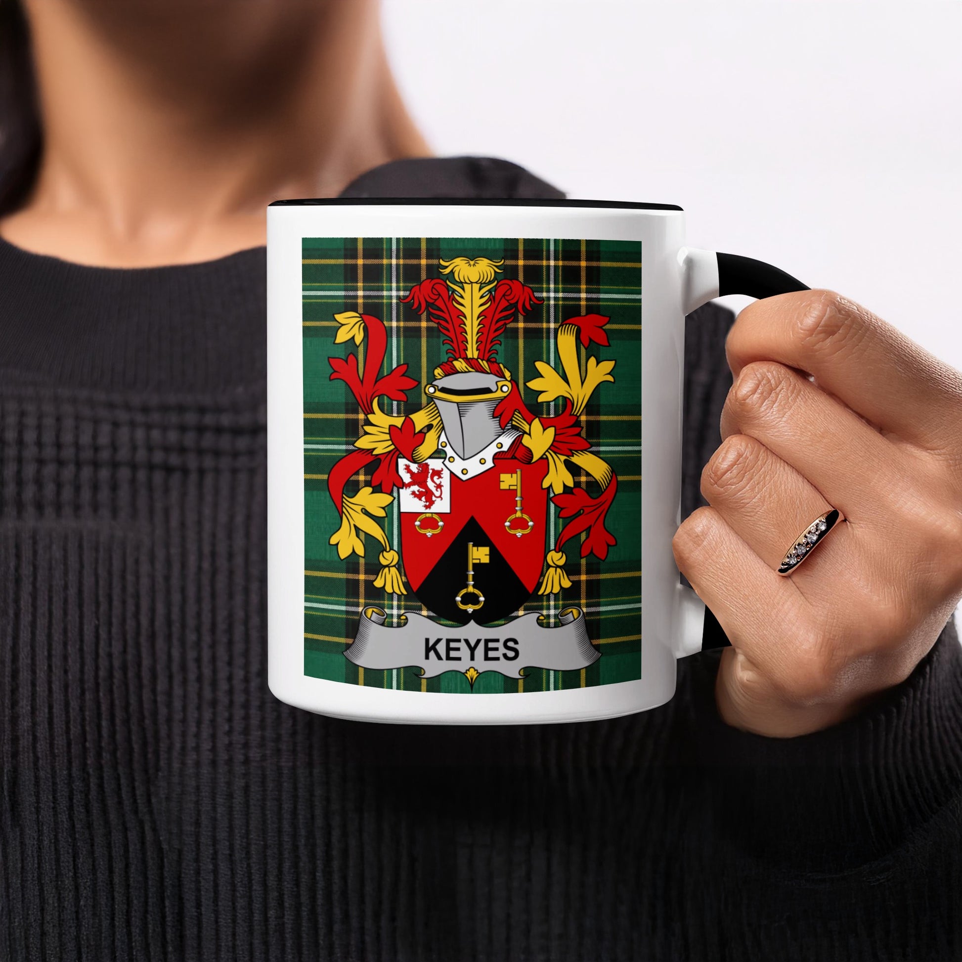 Black mug with a tartan plaid background featuring the Keyes family crest.