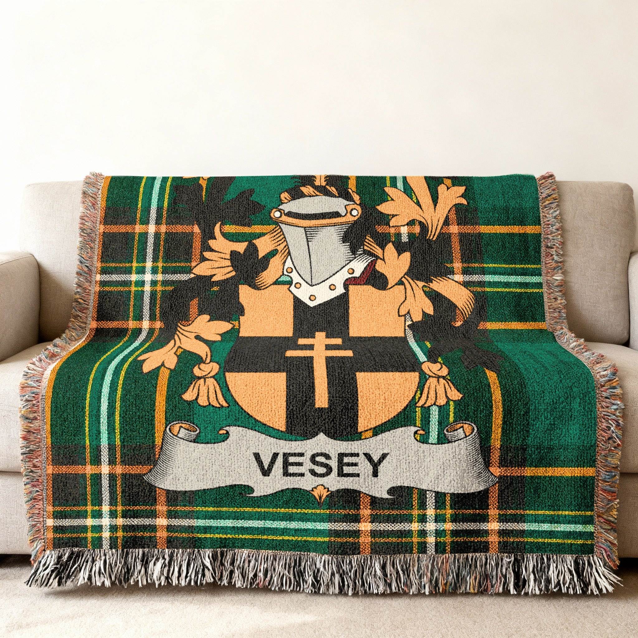 Green tartan blanket with a coat of arms bearing the name VESEY.