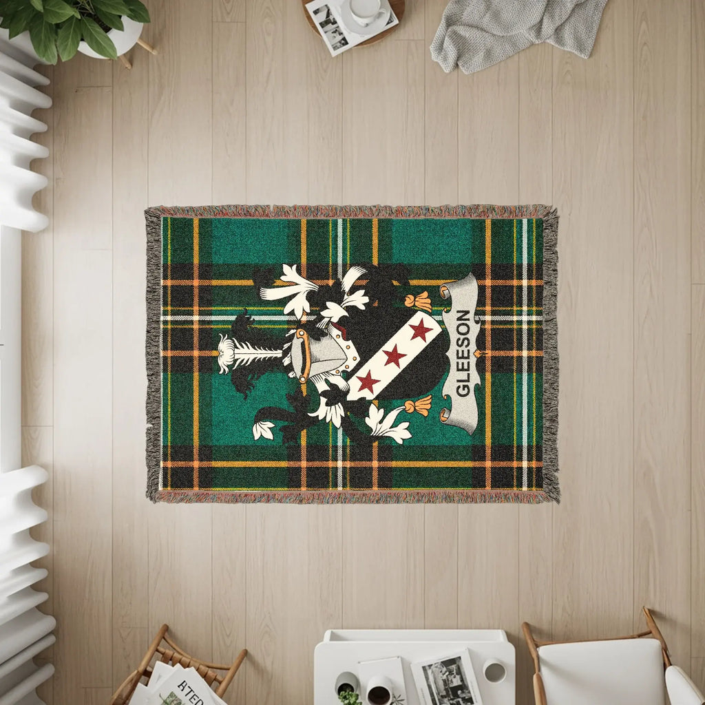 Plaid woven blanket with a family crest and the name GLEESON.