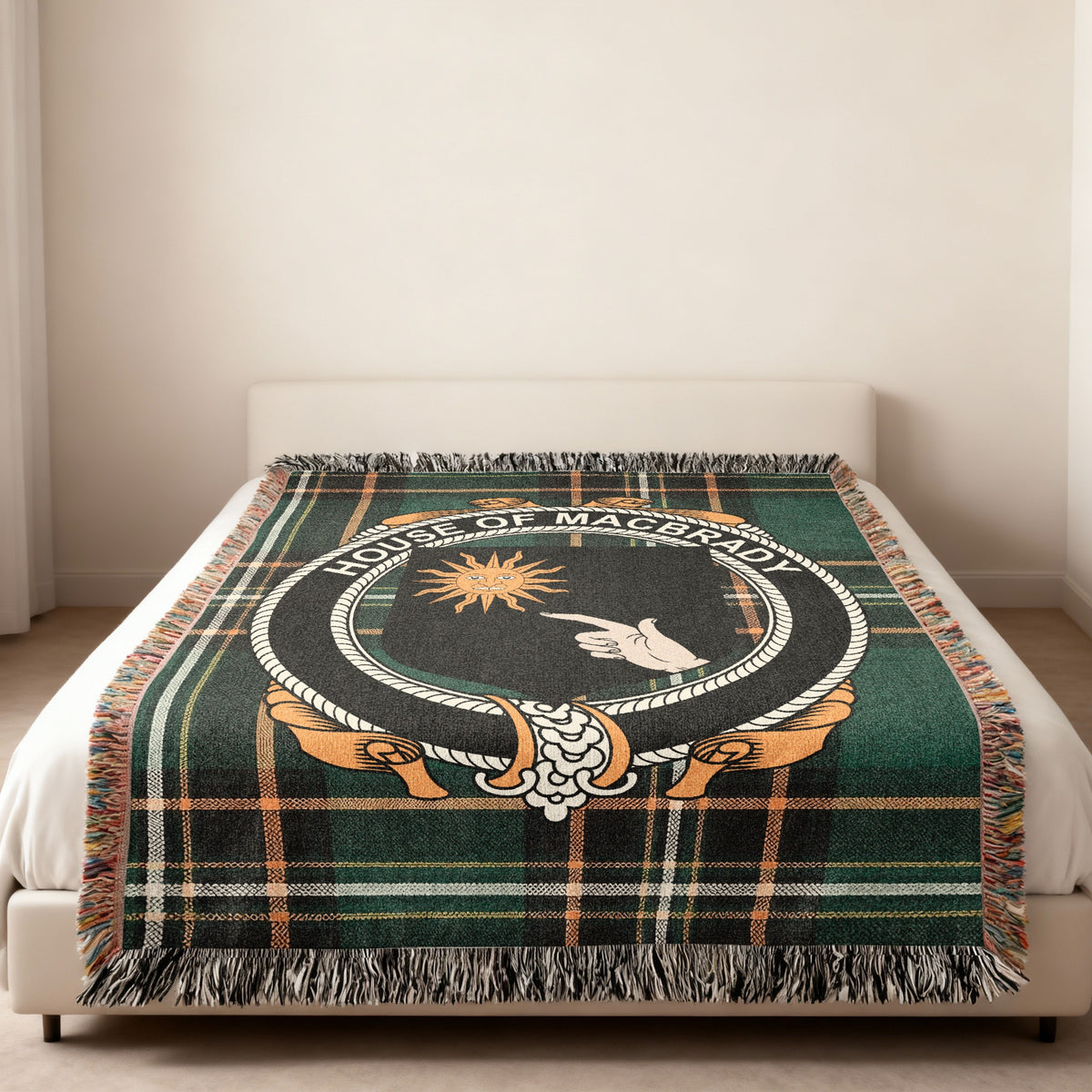 MacBrady family crest emblem woven blanket displayed on a bed