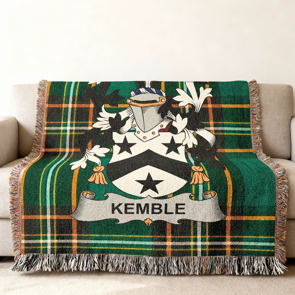 Green tartan throw blanket with Kemble family crest on a couch.