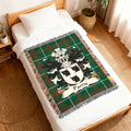 Woven throw blanket with green tartan pattern and the Parry family crest.