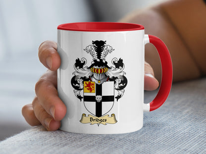 White mug with red handle featuring a coat of arms with the name "Bridges."