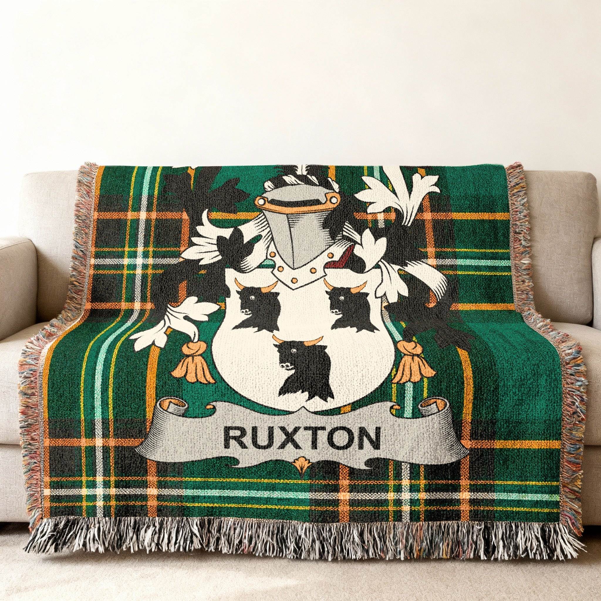 Woven blanket with green plaid and the Ruxton family crest.