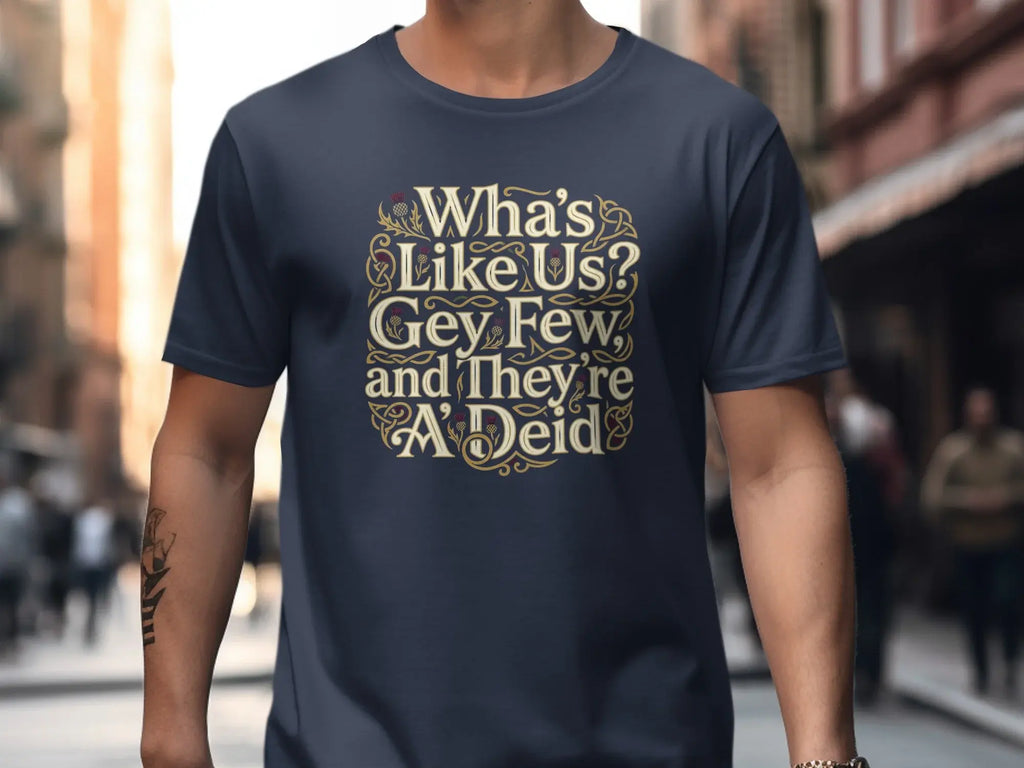 Navy t-shirt with "Wha's Like Us? Gey Few and They're A'Deid" text in gold Celtic knot design.