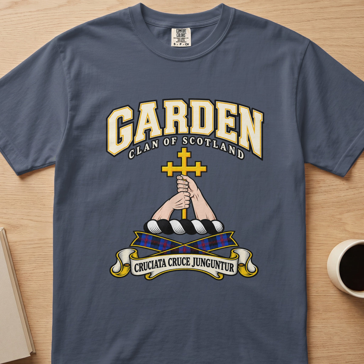 Garden clan T-shirt in slate blue, front view with hands holding a gold cross
