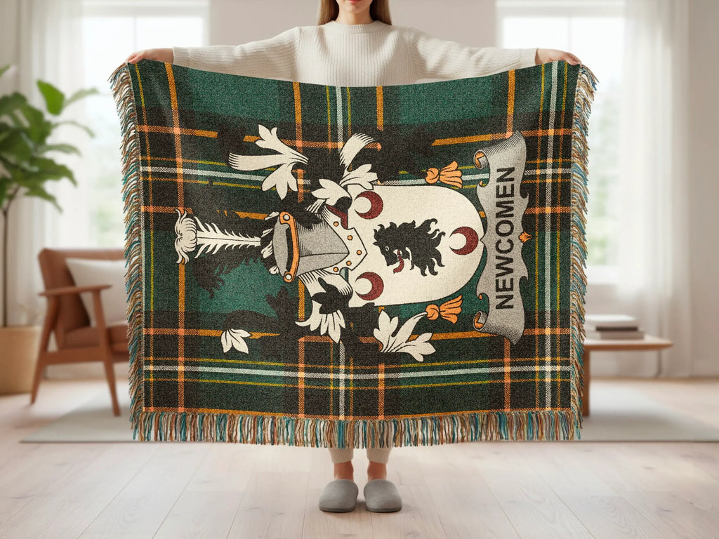 Tartan throw blanket with Newcom family crest and fringe detail.
