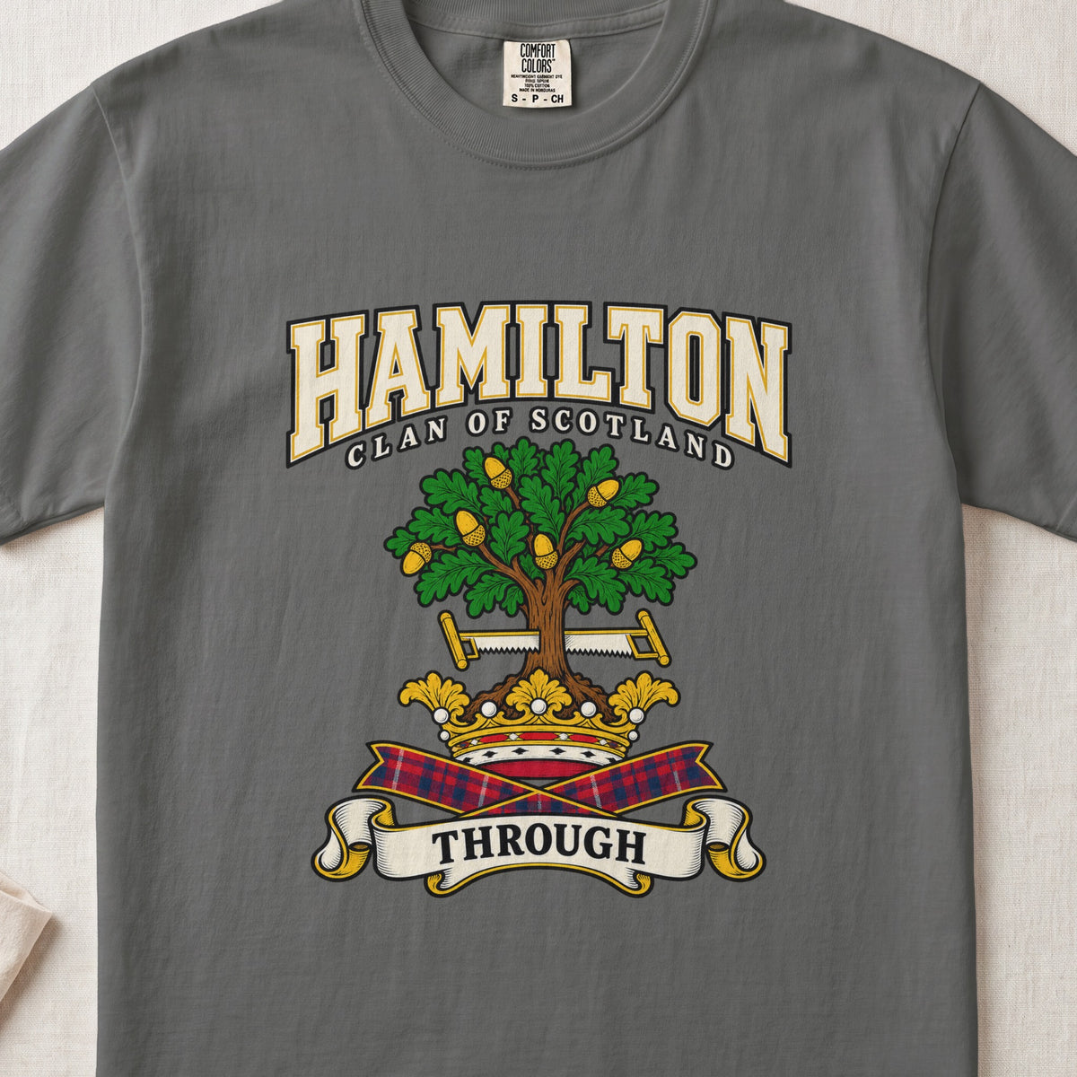 Hamilton graphic T-shirt in Pepper gray, front flat lay showing varsity lettering and green oak-like tree with gold acorns.