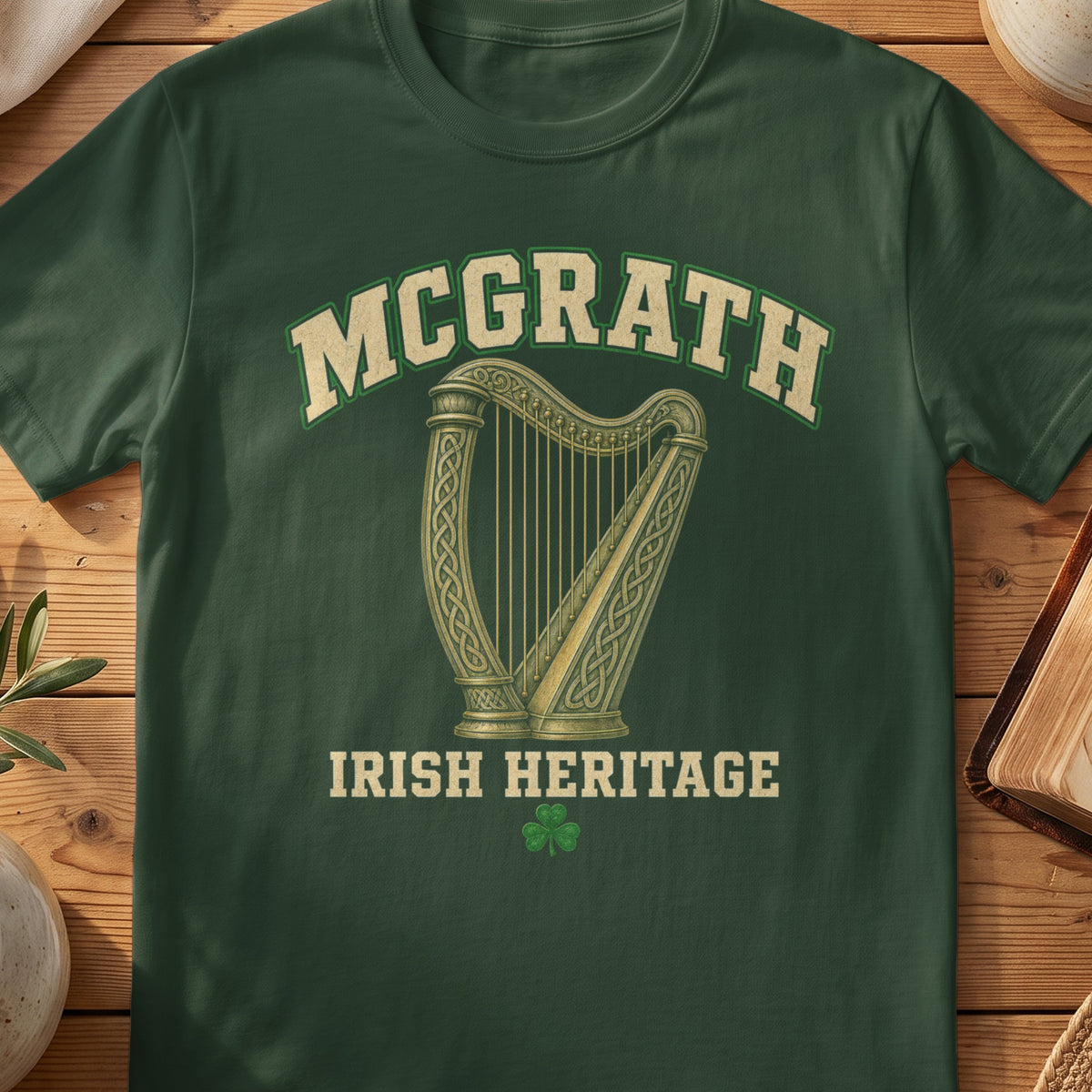 McGrath Irish harp T-shirt in Forest Green, with cream surname lettering, a gold-toned harp, green shamrock and “Irish Heritage” text.