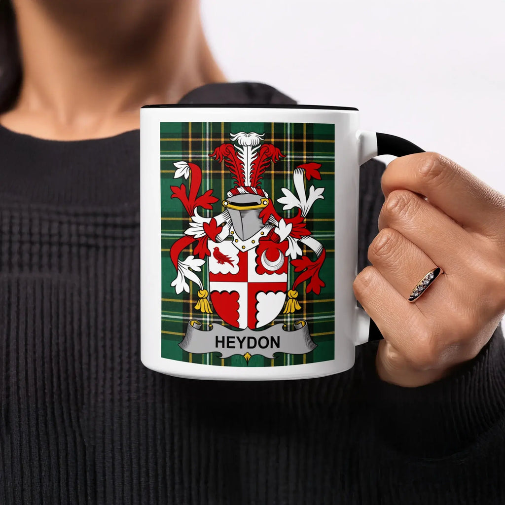 White mug with Heydon family crest on a plaid background.