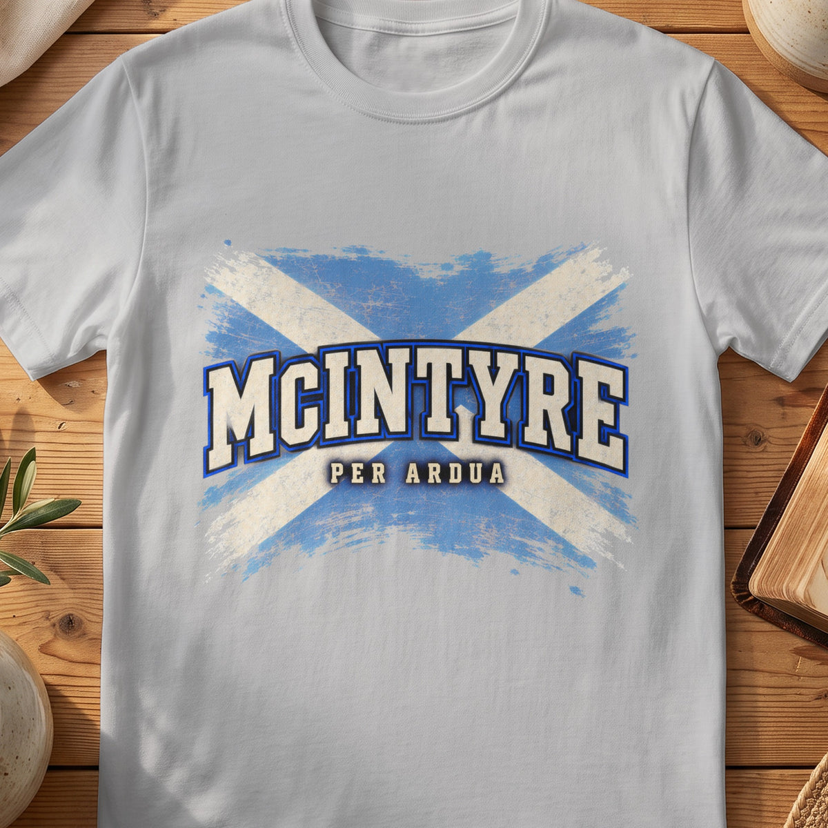 McIntyre Scottish Saltire T-shirt in Sport Grey, with distressed blue and cream flag and “Per Ardua” lettering.