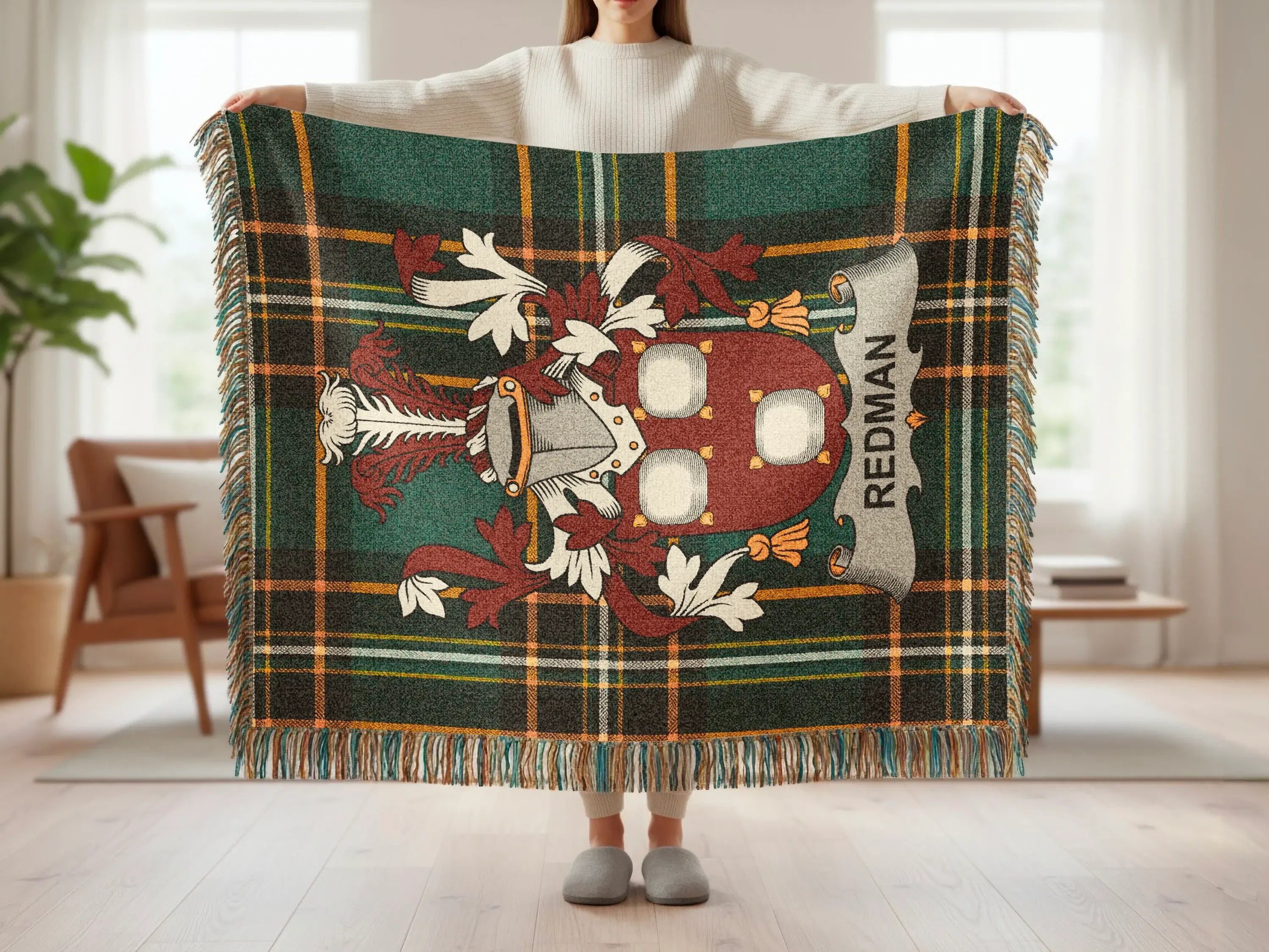 Tartan blanket with a coat of arms featuring the name "REDMAN" on a banner.