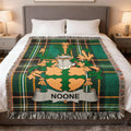 Green tartan blanket with a family crest and the name "NOONE".