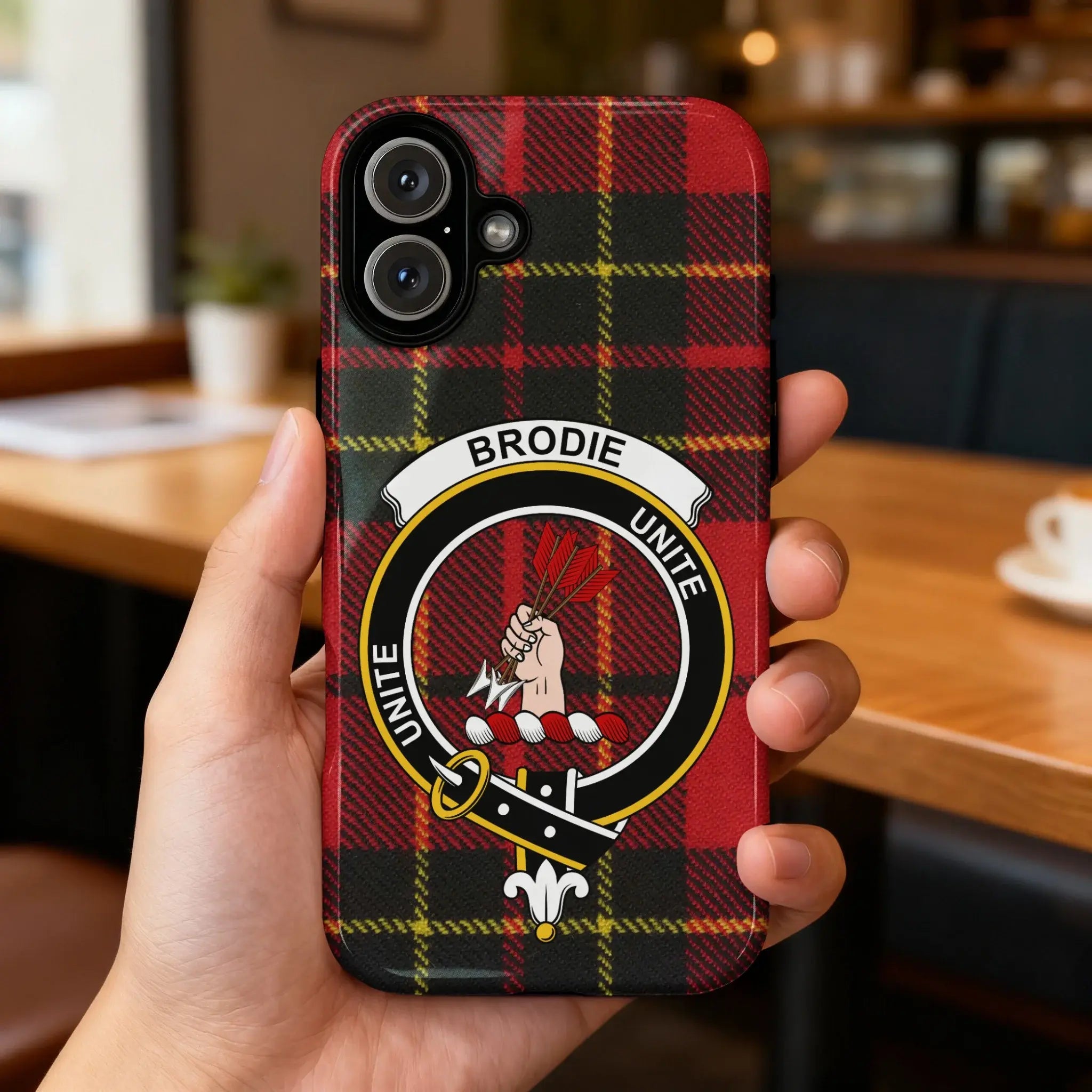 Clan Brodie Unite tartan case on iPhone — red plaid crest, glossy surface