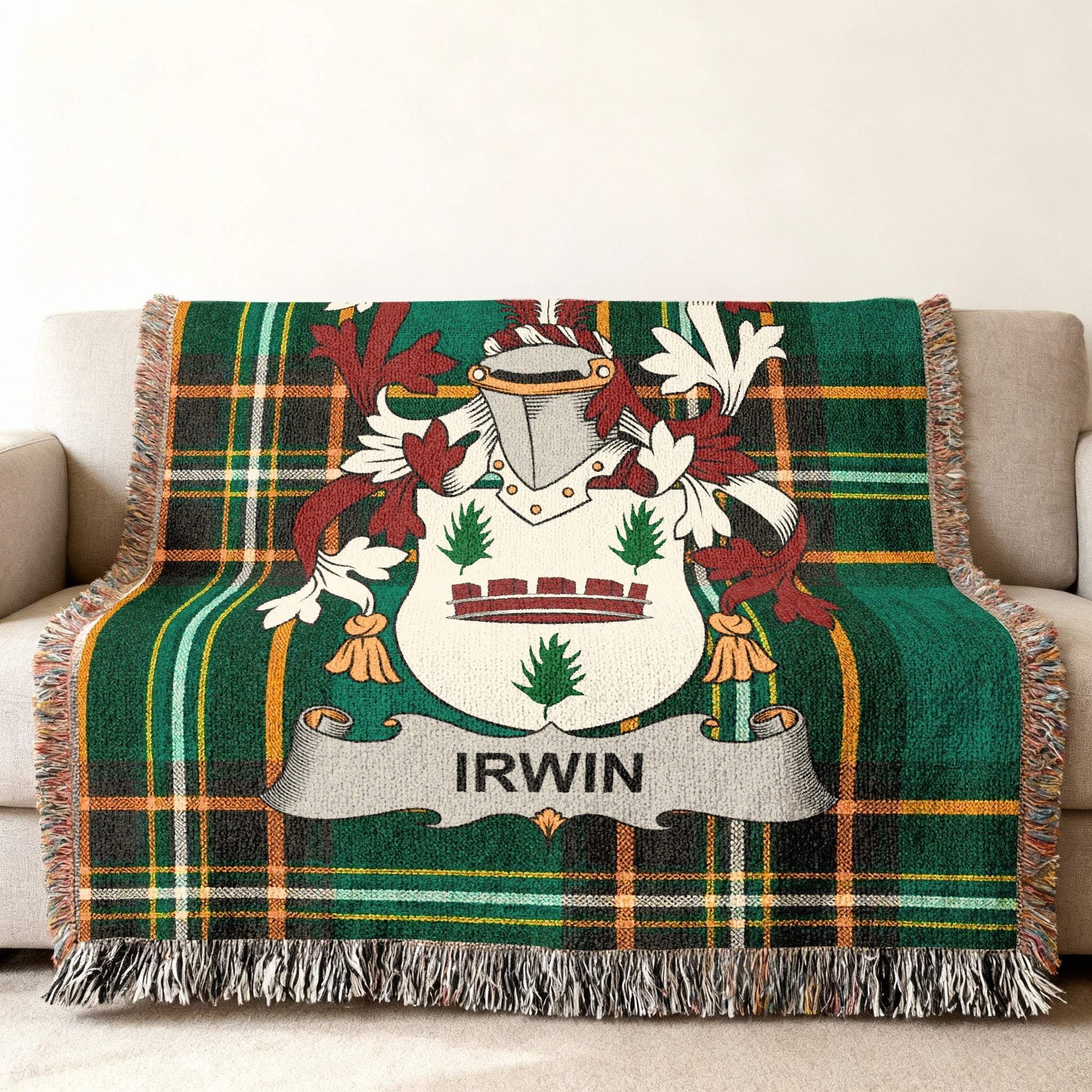Green tartan blanket with Irwin family crest draped on a couch.