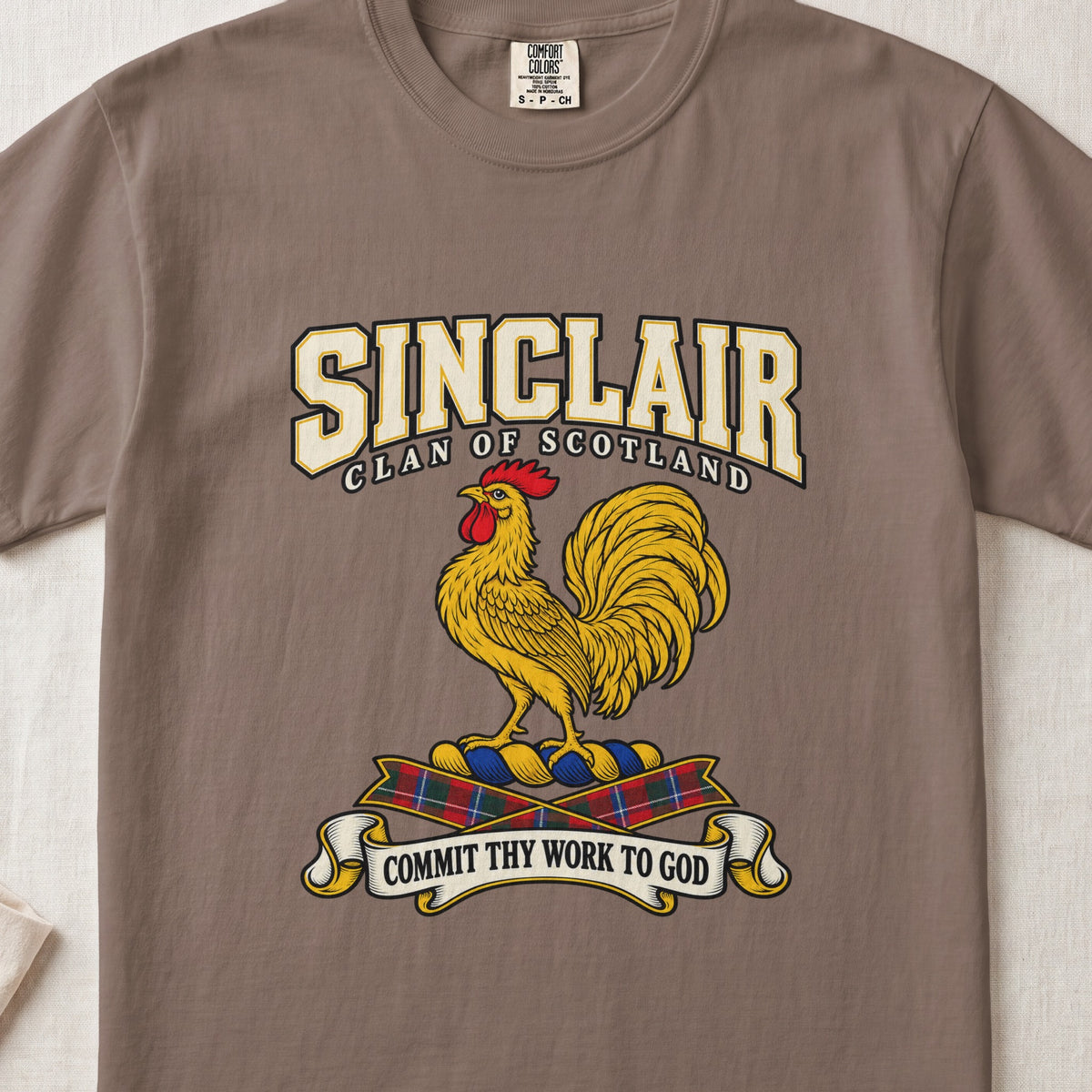 Sinclair graphic T-shirt in Espresso brown, front flat lay showing varsity lettering and gold rooster with red comb and wattle.