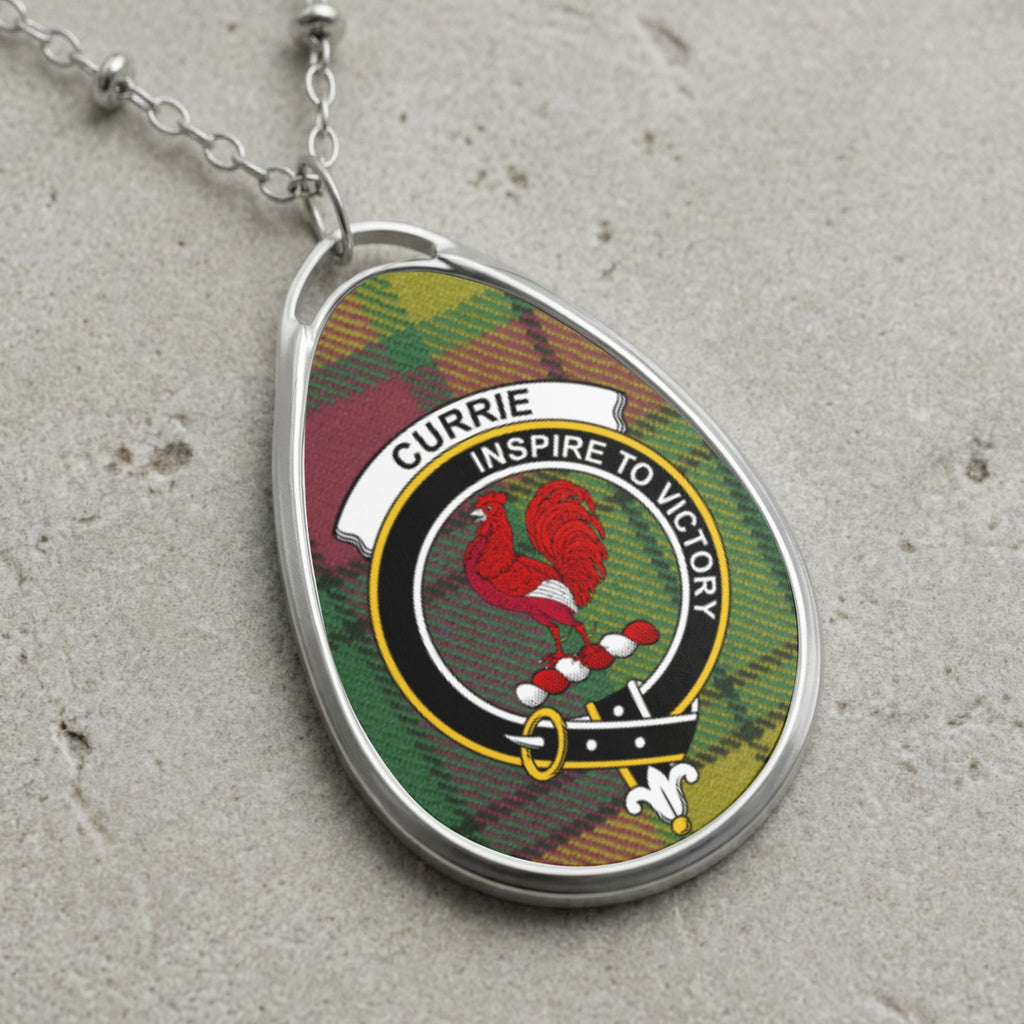 Currie clan Scottish tartan necklace with clan crest on tartan background