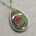 Currie clan Scottish tartan necklace with clan crest on tartan background