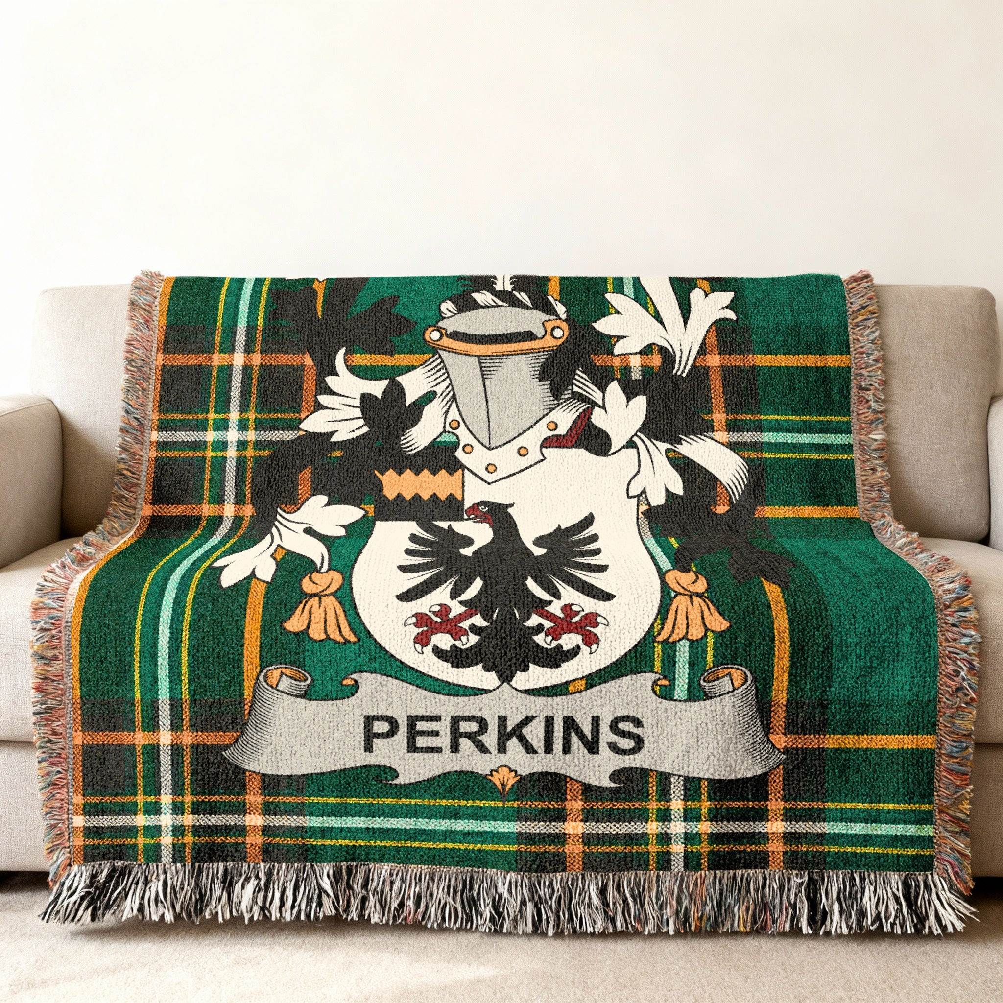 Perkins family crest on a green tartan plaid throw blanket.