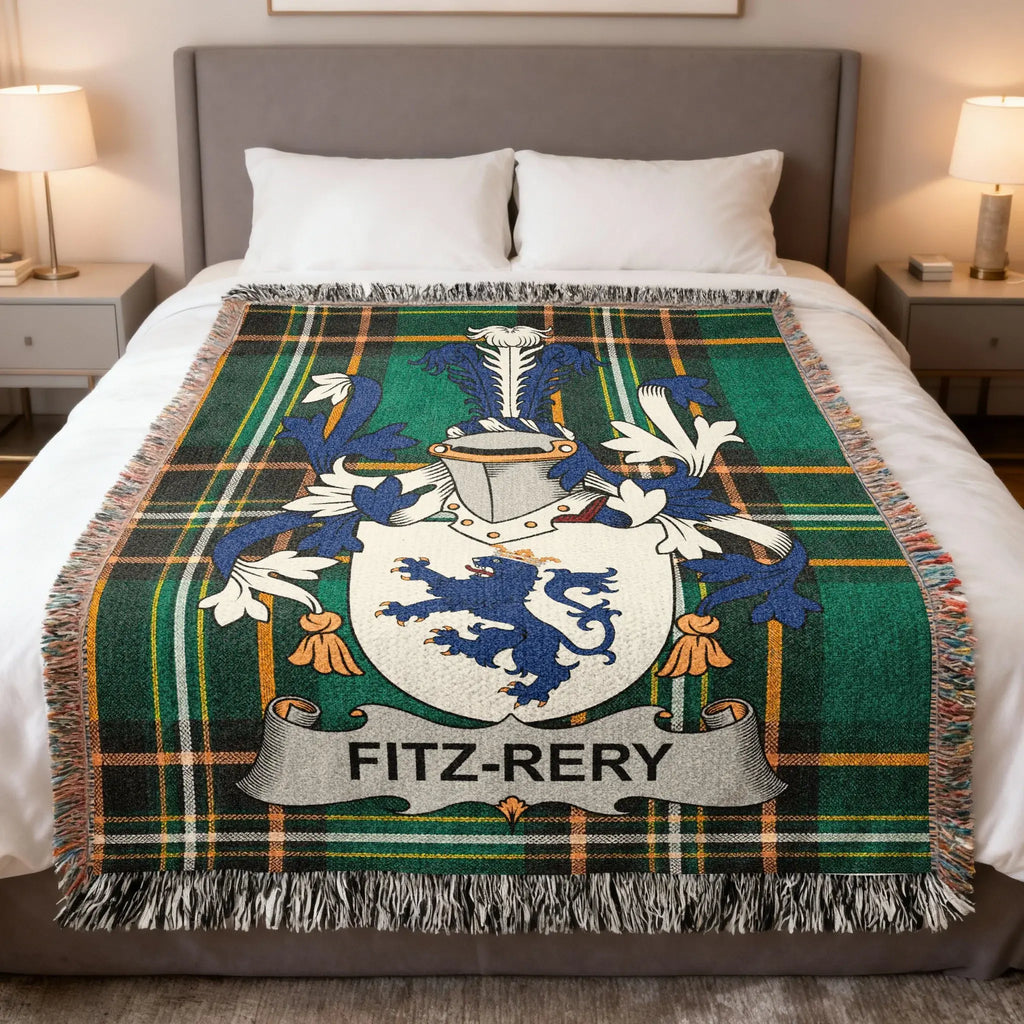 Fitz-Rery tartan blanket with a coat of arms and fringed edges on a bed.