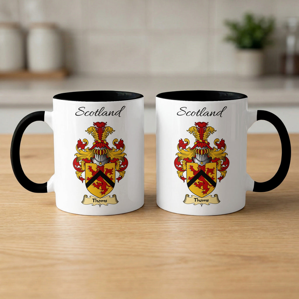 Pair of white Thoms Scottish family shield mugs with black accents