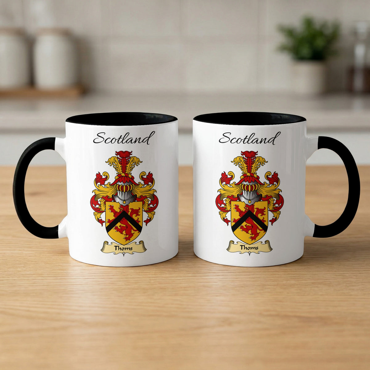Pair of white Thoms Scottish family shield mugs with black accents